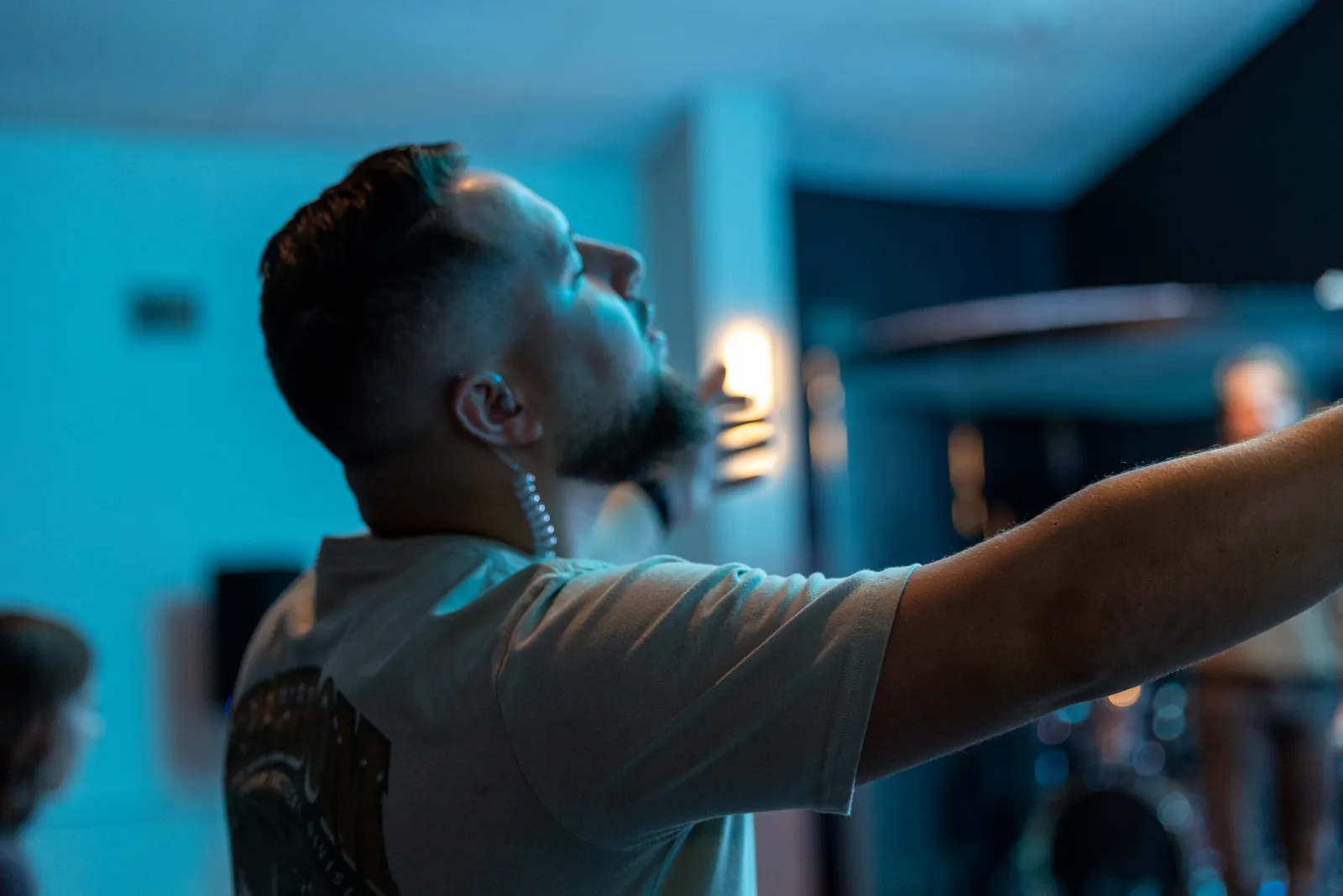 A man reaching out in worship during a Sunday gathering